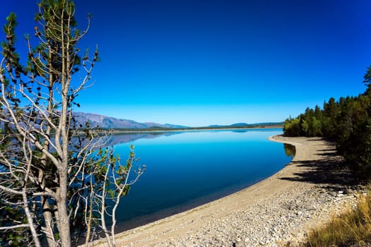 Jackson Lake with the landscape perfectly reflected in Grand Teton National Park in Wyoming
