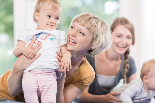 Young moms and their little children in mother and child course