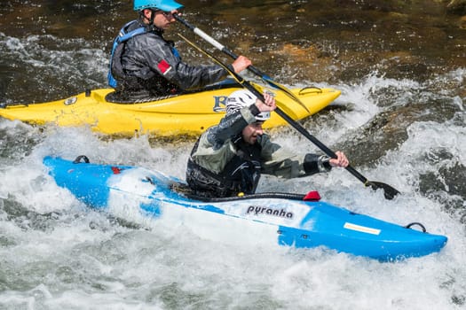 AROUCA, PORTUGAL - APRIL 23: Joao Tiago Silva on the blue kayak and unidentified athlete at the Paivafest on april 23, 2017 in Arouca, Portugal.
