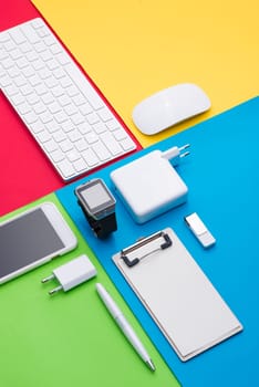 Well organised white office objects on colorful background