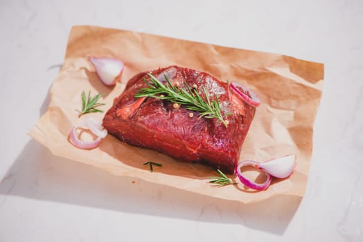 Raw beef on a cutting board  with spices and ingredients for cooking.