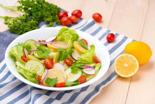 Homemade fresh green vegetable salad on table.