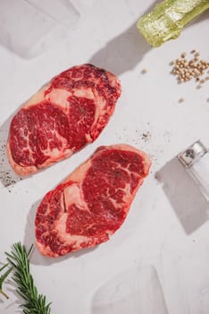 Raw beef on a cutting board  with spices and ingredients for cooking.