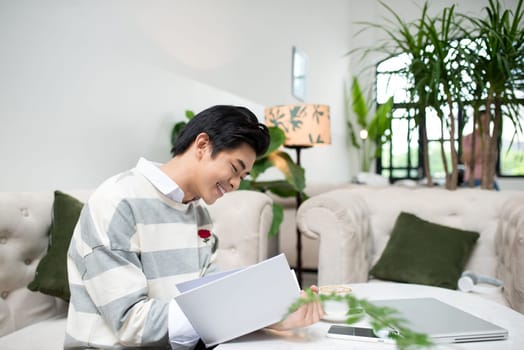 Asian entrepreneur reading book during coffee break