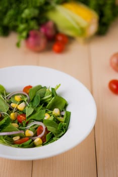 Homemade fresh green vegetable salad on table.