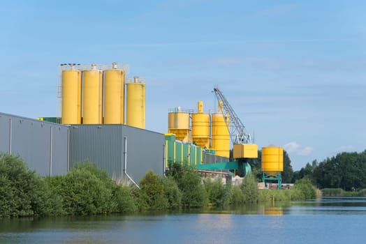 yellow silos belonging to a cement factory in the netherlands