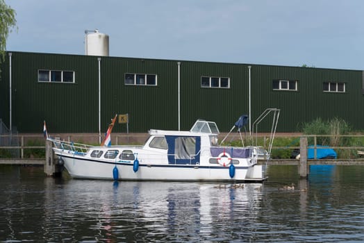 white yacht in the almelo harbor in the netherlands