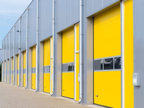 exterior of a commercial warehouse with yellow roller doors