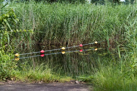 buoy line over a canal to prevent small boats to pass