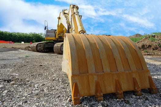 Close up of an excavator on blue sky.
