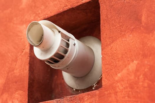 Chimney for smoke outlet on the wall. Forced circulation airtight double boiler. Outdoor flue and air intake.