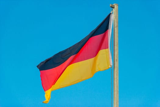 Waving flag of Germany with blue background