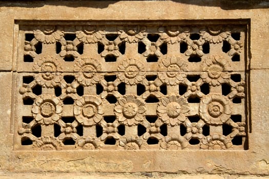 Artistically carved flower petals on stone window at Ladakhan Temple in Aihole, Bagalkot District, Karnataka, India, Asia