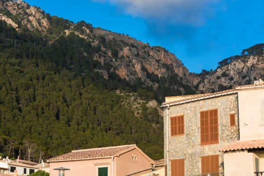View from the port of Valldemossa to the mountains with the narrow access road. .
