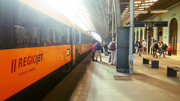 PRAGUE, CZECH REPUBLIC - JULY 10, 2015: Passengers get off the Student Agency train at the platform in the main Prague railway station in Prague, 2015. Student Agency company operates low cost trains in Czech Republic.