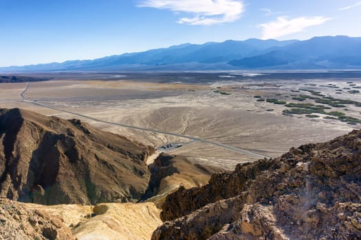 Beautiful landscape of Death Valley National Park with a parking lot visible below