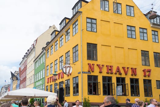 COPENHAGEN, DENMARK - JULY 31, 2016: Famous Nyhavn promenade with its colorful buildings. It is one of the most famous landmarks in the country