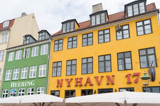 COPENHAGEN, DENMARK - JULY 31, 2016: Famous Nyhavn promenade with its colorful buildings. It is one of the most famous landmarks in the country