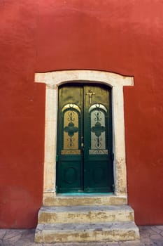 Red colonial building with an interesting door in Valladolid, Mexico