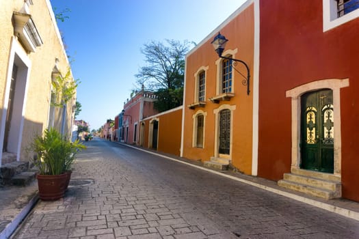 Street lined with colorful colonial buildings in Vallodlid, Mexico