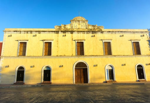 Yellow colonial building with a blue sky in Valladolid, Mexico