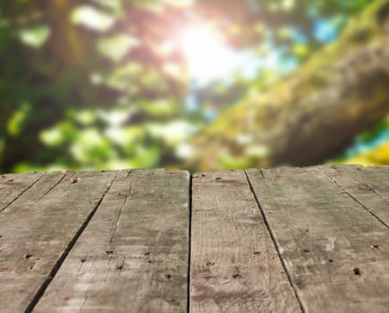 Old wooden used table on a blurred natural background