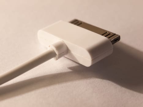 close up of a usb charger head for a mp3 player on a white background