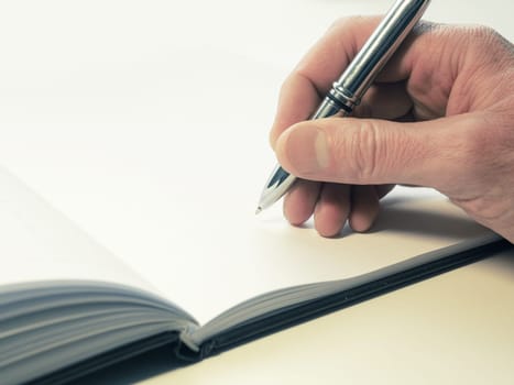 Business man signing a contract or writing a letter