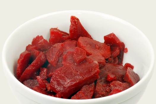 The beet salad is in white plate on white background.