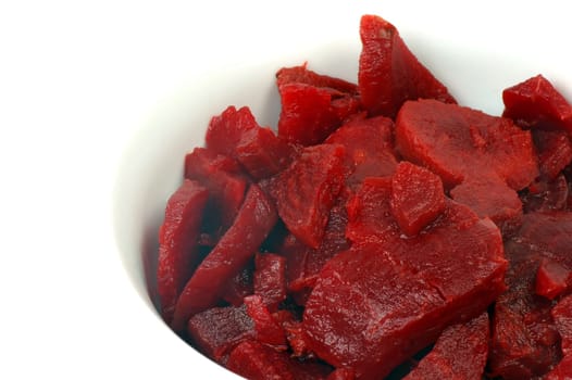 The beet salad is in white plate on white background.