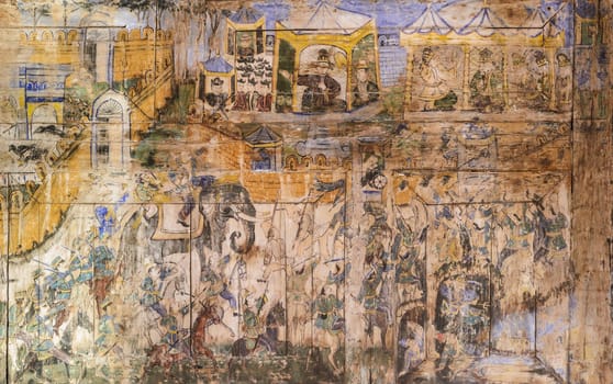 Ancient Thai mural painting on wooden temple wall in Lampang, Thailand