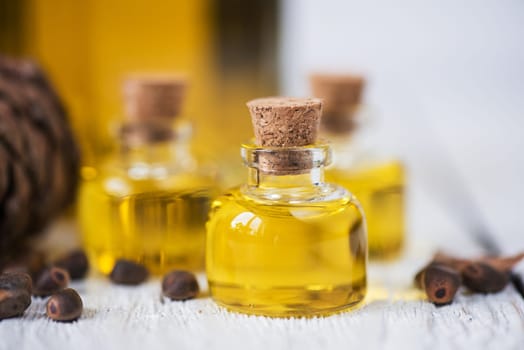 The cedar oil in a glass bottle on a white wooden background. Source of essential fatty acids for healthy nutrition