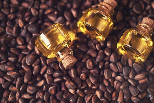 The cedar oil in a glass bottles on the cedar nuts