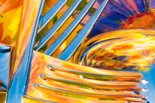 Fork and spoon against a colorful background