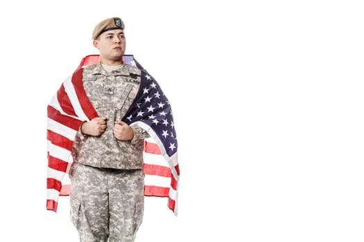 Army Ranger from Special Troops Battalion in universal Camouflage pattern Uniforms and Tan beret with Ranger Regiment crest standing weraing US flag on his shoulders. National holidays: Veterans Day, Memorial Day