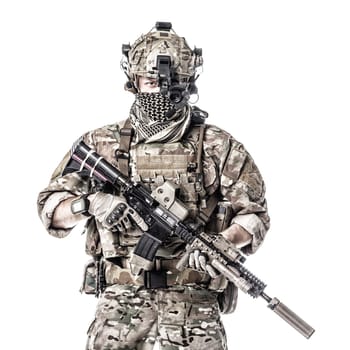 Army Ranger in field Uniforms with weapon, plate carrier and combat helmet are on, his face closed by Shemagh Kufiya scarf. Studio shot