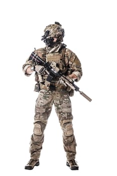 Army Ranger in field Uniforms with weapon, plate carrier and combat helmet are on, his face closed by Shemagh Kufiya scarf. Studio shot
