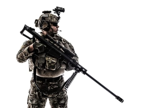 Army Ranger in field Uniforms with sniper rifle, plate carrier and combat helmet are on, his face closed by Shemagh Kufiya scarf. Studio shot
