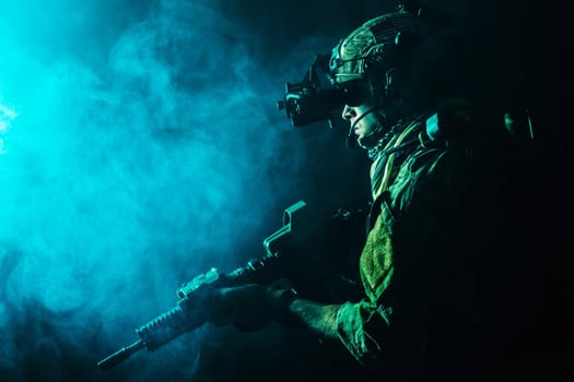 Security forces operator in Combat Uniforms with rifle, in the face of danger. Facing enemy, he is ready to fight. Studio contour silhouette shot, toned and colorized, backlight, profile side view