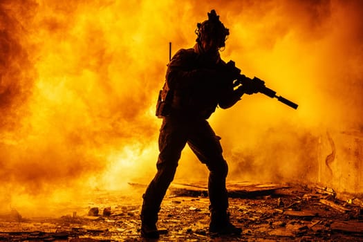 Black silhouettes of soldier in the smoke fire burning moving in battle operation. Back light
