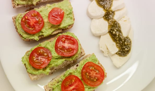 healthy diet sandwiches with guacamole and cherry tomatoes mozzarella cheese