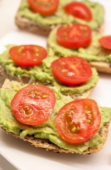 healthy diet sandwiches with guacamole and cherry tomatoes