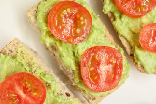 healthy diet sandwiches with guacamole and cherry tomatoes