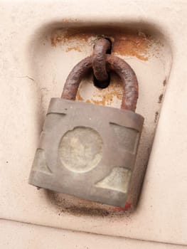 an old and rusty locked padlock outside
