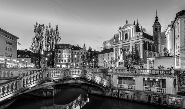 Romantic Ljubljana's city center in black and white: river Ljubljanica, Triple Bridge - Tromostovje, Preseren square and Franciscan Church of the Annunciation. Ljubljana, Slovenia, Europe.
