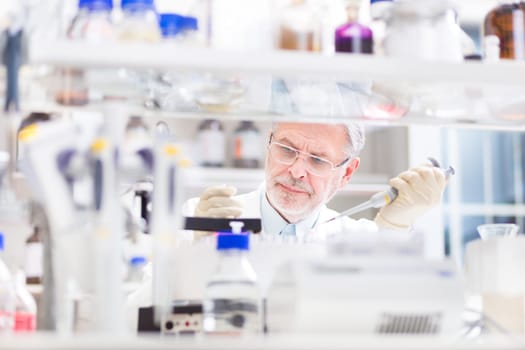 Life scientist researching in laboratory. Life sciences study living organisms on the level of microorganisms, viruses, human, animal and plant cells, genes, DNA...