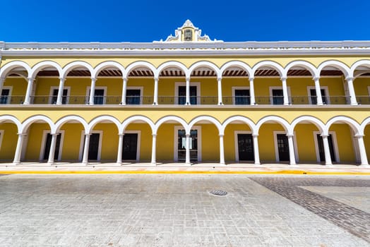 Facade of a yellow colonial building in Campeche, Mexico