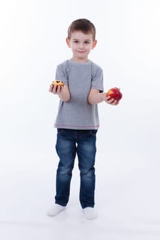 little boy with food isolated on white background - apple or a muffin