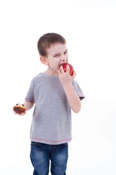 little boy with food isolated on white background - apple or a muffin
