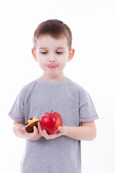 little boy with food isolated on white background - apple or a muffin